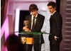The Social Network co-stars Jesse Eisenberg and Andrew Garfield accept David Fincher's BAFTA on his behalf. 