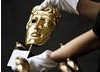 BAFTA masks are polished before the British Academy Television Awards.