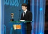Harry Potter star Daniel Radcliffe on stage to present the Award for Outstanding British Contribution to Cinema (pic:BAFTA / Camera Press).