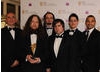 CBBC presenter Michael Underwood and Populous creator Peter Molyneux presented the BAFTA Ones To Watch Award to Boro Toro creators Adam Westwood, Graham Ranson, Yves Wheeler, Matthew Booton and Owen Schwehr (BAFTA / James Kennedy). 