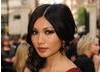 Doctor Who actress Gemma Chan looks beautifully sleek with a sophisticated centre parting, and lightly curled hair draped over one shoulder.