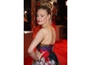 Actress Romola Garai poses on the Film Awards red carpet in a flowery dress (BAFTA/Dave Dettman).