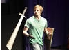 Actor Bradley James shows the audience one of Prince Arthur’s favourite sword flourishes (BAFTA / Jonny Birch).