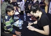 Actress Kaite McGrath signs autographs for young fans after the event (BAFTA / Jonny Birch).