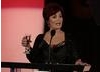 Evening's host Sharon Osbourne take to the stage with drink in hand......