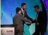 Chris O'Dowd and Miles Jacobson welcome Keith Ramsdale to the stage to accept the award for Use of Online of behalf on the development team behind FIFA 10 (BAFTA/Brian Ritchie)