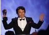 Shigeru Miyamoto celebrates his Academy Fellowship with a cheer on stage at the end of the awards ceremony (BAFTA/Brian Ritchie)