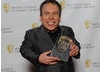 Professor Flitwick in the Harry Potter series Warwick Davis with the award for the final film, which won after more than 400,000 7-14-year-olds went to www.baftakidsvote.org to cast their votes. 