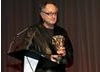 Wolf's son and fellow cinematographer Peter Suschitzky, prepares to present his father with the BAFTA Award.