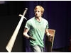Actor Bradley James shows the audience one of Prince Arthur’s favourite sword flourishes (BAFTA / Jonny Birch).