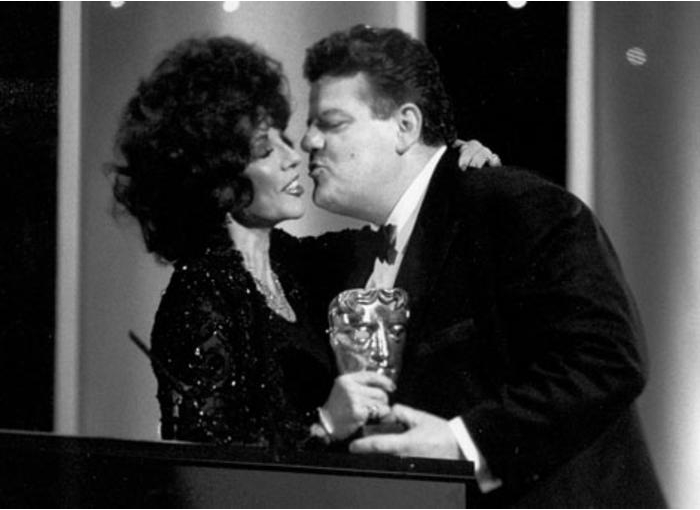 Joan Collins presents Robbie Coltrane with the Best Actor award for Cracker in 1994.