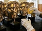 BAFTA masks are polished before the British Academy Television Awards.