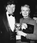 MICHAEL WILLIAMS with JUDI DENCH winner of the 1988 ACTRESS IN A SUPPORTING ROLE Award for her performance in a HANDFUL OF DUST (1988) at the Awards Ceremony in 1989