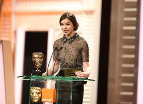 True Grit star and Leading Actress nominee Hailee Steinfeld announces the Make Up & Hair winner. (Pic: BAFTA/Stephen Butler)