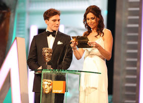 Sam Claflin (Pirates Of The Caribbean: On Stranger Tides) and Minnie Driver (Barney's Version) announce the Production Design winner. (Pic: BAFTA/ Stephen Butler)
