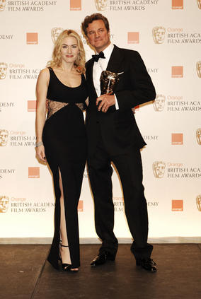 Winner of the Leading Actor Award, Colin Firth, celebrates with the Leading Actress Award winner in 2009, Kate Winslet (BAFTA/Richard Kendal).