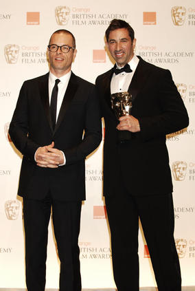 Guy Pearce stands with Sheldon Turner after presenting him with the Adapted Screenplay award (BAFTA/Richard Kendal).