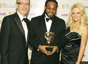 Gavin Russell celebrates the Artistic Achievement Award for the innovative Flower with citation readers Emily Attack and Dave Gibbons (BAFTA/Steve Butler).