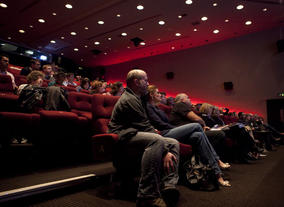 Audience members listen to a discussion about producing VFX on a low budget.