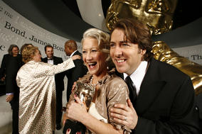 Academy winner Helen Mirren shows off her Actress Award with the ceremony host, Jonathan Ross (BAFTA).