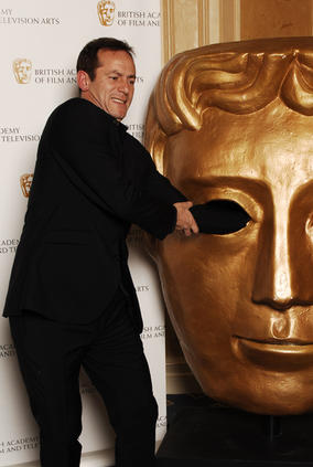Jason Isaacs has run-in with the BAFTA mask (BAFTA / Richard Kendal).
