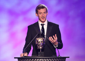Global Mountaineer Jake Meyer climbs on stage to present the Factual Award.
