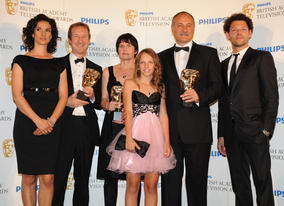 The Unloved team receives their BAFTA for Single Drama from presenters Richard Coyle and Indira Varma (BAFTA/Richard Kendal).