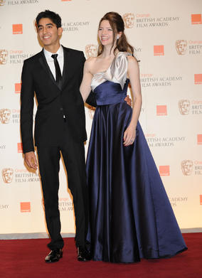 Dev Patel and Talulah Riley announced Alice In Wonderland as the Costume Design winner. (Pic: BAFTA/Richard Kendal)
