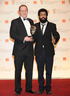 Four Lions actors Nigel Lindsay and Adeel Akhtar accept on behalf of writer/director Chris Morris. (Pic: BAFTA/ Richard Kendal)