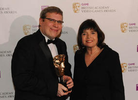 Barry Caudill celebrates his win in the Strategy category for Sid Meier's Civilization Revolution. The mask was presented by Barbara Follett MP (BAFTA / James Kennedy). 