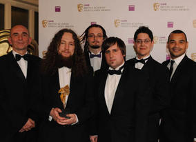 CBBC presenter Michael Underwood and Populous creator Peter Molyneux presented the BAFTA Ones To Watch Award to Boro Toro creators Adam Westwood, Graham Ranson, Yves Wheeler, Matthew Booton and Owen Schwehr (BAFTA / James Kennedy). 