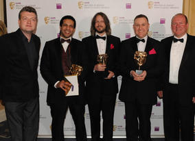 Charlie Booker and Ian Livingstone presented the Artistic Achievement Award to Kareem Ettouney, Mark Healey and Leo Cubbin for LittleBigPlanet (BAFTA / James Kennedy). 