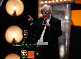 Joe Dunton dons a pair of 3D glasses after receiving the honour for Outstanding British Contribution to Cinema award (BAFTA/Brian Ritchie).
