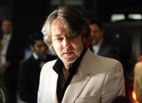 The TV presenter and avid gamer greets press on the red carpet.