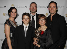 Winners of the Drama award for 'Rhestr Ndolig Wil (Wil's Christmas LIst)' with citation reader, Jason Isaacs.
