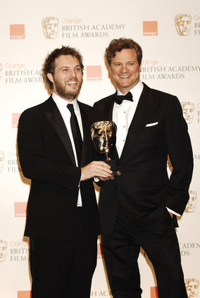Duncan Jones celebrates with actor Colin Firth after winning the Outstanding Debut by a British Writer, Director of Producer Award for his sci-fi adventure Moon (BAFTA/Richard Kendal)