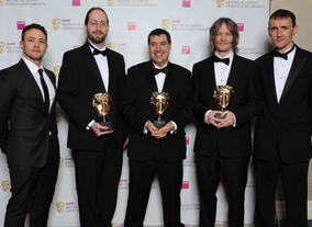 Presenters Warren Brown (l) and Pete Williamson (r) with winners Mark Healey, David Smith and Pete Smith. The jury praised the game’s new editor tools which “takes user generated content from a simple ‘level’ to a full game.”