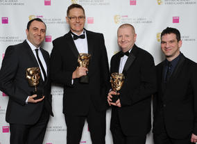 Sports Interactive's Miles Jacobson (r) with winners Scott Henson, Craig Duncan and Lee Schuneman. The jury described the game as “a delight to play and a challenge to master.”