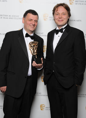 Stephen Moffat, winner of the Writer BAFTA, poses with actor and Award presenter Shaun Dooley