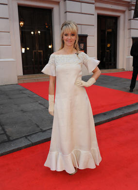 The TV and radio presenter gets ready to host the BBC's red carpet coverage, in a vintage Dior gown. She also wears gold and diamond Woodland hoop earrings, a yellow Daisy ring and a gold calla Lily ring all by Asprey.
