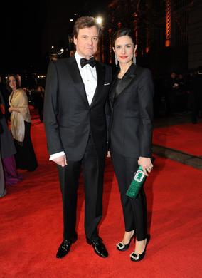Leading Actor winner of the previous year, Colin Firth in Armani and his wife in a Paul Smith tux with vintage Cartier tassel earrings from 1907 with emeralds and diamonds.
