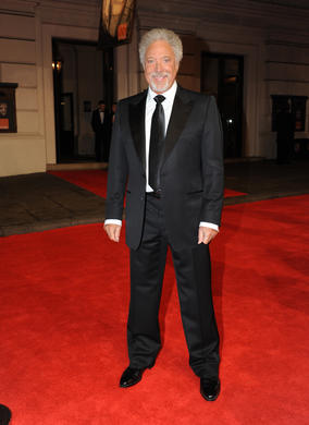 The legendary crooner will be opening the ceremony with his Bond theme, Thunderball. Jones is in a suit by Tom Ford.