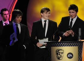 Dan Pearce, Sam Taylor and James Cook of Beached Whale Productions take the BYGD award for their game HAMSTER: Accidental World Domination. Pic: BAFTA/Steve Finn