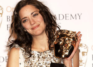 French actress Marion Cotillard cradles her BAFTA for Leading Actress. 